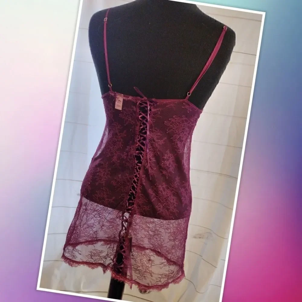 Victoria Secret XS maroon lace top. Features lace tie on the back, gold accent